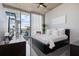 Sleek bedroom features modern platform bed, balcony with city views and dark, glossy floors at 155 S Court Ave # 1610, Orlando, FL 32801