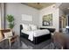 Modern bedroom with hardwood chair, art and plant with a large bed at 155 S Court Ave # 1610, Orlando, FL 32801