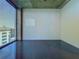 Empty bedroom with dark tile floor, floor-to-ceiling windows and cityscape views at 155 S Court Ave # 1610, Orlando, FL 32801