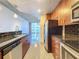 Modern kitchen showcasing stainless steel appliances, granite countertops, tile backsplash, and designer lighting at 155 S Court Ave # 1610, Orlando, FL 32801
