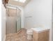Bathroom featuring a glass enclosed shower, tile flooring, toilet, and a skylight at 5100 Linwood Cir, Sanford, FL 32771