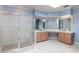 Bathroom featuring a glass-enclosed shower, a makeup vanity, and tile flooring at 5100 Linwood Cir, Sanford, FL 32771