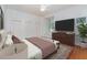 Bright bedroom featuring hardwood floors, a ceiling fan, and a window seat for relaxation at 5100 Linwood Cir, Sanford, FL 32771