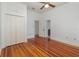 Bright bedroom featuring wood floors, neutral walls, closet and ceiling fan at 5100 Linwood Cir, Sanford, FL 32771