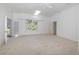 Bright bedroom with carpet flooring, skylight, crown moulding and a large window overlooking mature landscaping at 5100 Linwood Cir, Sanford, FL 32771