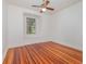 Charming bedroom with window, shutters, hardwood floors, and white trim at 5100 Linwood Cir, Sanford, FL 32771