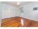 Bright bedroom with a window, built-ins and hardwood floors at 5100 Linwood Cir, Sanford, FL 32771