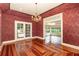 Bright dining room features decorative wallpaper, chandelier, hardwood floors, and French doors at 5100 Linwood Cir, Sanford, FL 32771