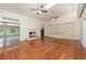 Bright living room features vaulted ceiling, fireplace, hardwood floors, and large built-in shelving unit at 5100 Linwood Cir, Sanford, FL 32771