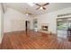 Spacious living room boasts vaulted ceiling, fireplace, hardwood floors, and large windows offering ample natural light at 5100 Linwood Cir, Sanford, FL 32771