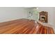 Bright living room featuring hardwood floors and a fireplace with access to an adjacent sunroom at 5100 Linwood Cir, Sanford, FL 32771
