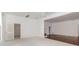 Living room featuring carpet flooring, wood floors in an adjacent room, and access to bedroom with closet at 5100 Linwood Cir, Sanford, FL 32771