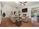 Bright living room with hardwood floors, fireplace and modern ceiling fans, and a skylight at 5100 Linwood Cir, Sanford, FL 32771
