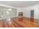 Spacious living room showcases hardwood floors, fireplace, and seamless flow into adjacent rooms at 5100 Linwood Cir, Sanford, FL 32771