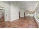 Bright sunroom featuring lots of natural light, neutral decor, white brick, and tile floors at 5100 Linwood Cir, Sanford, FL 32771