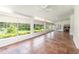 Inviting sunroom filled with natural light from large windows, neutral decor, and tile floors at 5100 Linwood Cir, Sanford, FL 32771