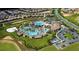 A captivating aerial view of a community pool area and surrounding neighborhood at 1585 Mulligan Blvd, Davenport, FL 33896