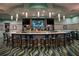 Upscale bar with stylish blue seating, a vibrant carpet, and a well-stocked counter for residents and guests at 1585 Mulligan Blvd, Davenport, FL 33896