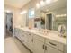 Elegant bathroom with double vanity, large mirror, and walk-in shower at 2310 Hamilton Ridge Rd, Clermont, FL 34715