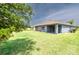 Spacious backyard with a covered patio, ideal for outdoor entertaining and relaxation at 2950 Gibraltar Blvd, New Smyrna Beach, FL 32168