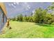 Expansive backyard featuring lush green grass and mature trees providing ample shade at 2950 Gibraltar Blvd, New Smyrna Beach, FL 32168