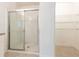 Bathroom with glass shower door and adjacent closet storage, providing functionality at 2950 Gibraltar Blvd, New Smyrna Beach, FL 32168