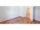 Open bedroom features wood floors and a door leading to another room at 2950 Gibraltar Blvd, New Smyrna Beach, FL 32168
