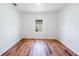Light filled bedroom with hardwood floors and a large window at 2950 Gibraltar Blvd, New Smyrna Beach, FL 32168