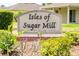 Isles of Sugar Mill community sign with manicured landscaping, offering a warm welcome at 2950 Gibraltar Blvd, New Smyrna Beach, FL 32168
