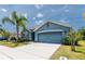 Beautiful blue single-Gathering home with a two-car garage, lush landscaping, and inviting curb appeal at 2950 Gibraltar Blvd, New Smyrna Beach, FL 32168