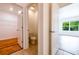 Hallway view leading to a powder room, bedroom and closet, all with modern finishes at 2950 Gibraltar Blvd, New Smyrna Beach, FL 32168