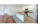 Well-lit kitchen featuring an island with a sink and ample counter space, connecting to the living area at 2950 Gibraltar Blvd, New Smyrna Beach, FL 32168