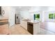 Bright kitchen featuring white cabinetry, stainless steel appliances, and a functional island at 2950 Gibraltar Blvd, New Smyrna Beach, FL 32168
