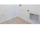 Bright laundry room featuring white walls, tile floor and hookups at 2950 Gibraltar Blvd, New Smyrna Beach, FL 32168