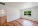 Bright living room featuring wood floors and a large window with outdoor views at 2950 Gibraltar Blvd, New Smyrna Beach, FL 32168