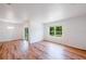 Bright living room featuring wood floors, modern lighting, and a sliding glass door at 2950 Gibraltar Blvd, New Smyrna Beach, FL 32168