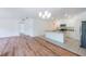 Spacious open-concept area featuring hardwood floors and a view into the bright kitchen area at 2950 Gibraltar Blvd, New Smyrna Beach, FL 32168