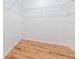 Empty walk-in closet features durable wood flooring and multiple shelves at 2950 Gibraltar Blvd, New Smyrna Beach, FL 32168