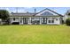 Expansive backyard showcasing lush green grass, an outdoor seating area, and lake views at 301 Richard Pl, Orlando, FL 32806