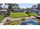 Gorgeous backyard featuring a spacious lawn, mature trees and private access to the lake at 301 Richard Pl, Orlando, FL 32806