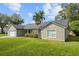Lovely single-Gathering home with an attached two-car garage and tropical palm trees at 301 Richard Pl, Orlando, FL 32806