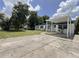 Front view of the house with a carport and yard at 902 San Domingo Rd, Orlando, FL 32808