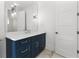 Bathroom with a navy blue vanity and white countertop at 1840 Biscayne Dr, Winter Park, FL 32789