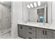 Grey bathroom with double vanity and a walk-in shower at 1840 Biscayne Dr, Winter Park, FL 32789