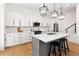 Modern kitchen with white cabinets, island, and stainless steel appliances at 1840 Biscayne Dr, Winter Park, FL 32789