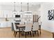 Modern kitchen with white cabinets, island, and hardwood floors at 1840 Biscayne Dr, Winter Park, FL 32789