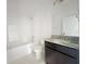 Bathroom with dark vanity, granite countertop, and white subway tile at 4376 Sagefield Dr, Harmony, FL 34773