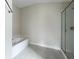 Bathroom with soaking tub, tiled flooring, and frameless glass shower enclosure at 4376 Sagefield Dr, Harmony, FL 34773