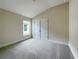 Spacious bedroom with gray carpet, neutral walls, double doors to closet, and a window at 4376 Sagefield Dr, Harmony, FL 34773