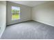 Bright bedroom with carpeted floor and large window at 4376 Sagefield Dr, Harmony, FL 34773